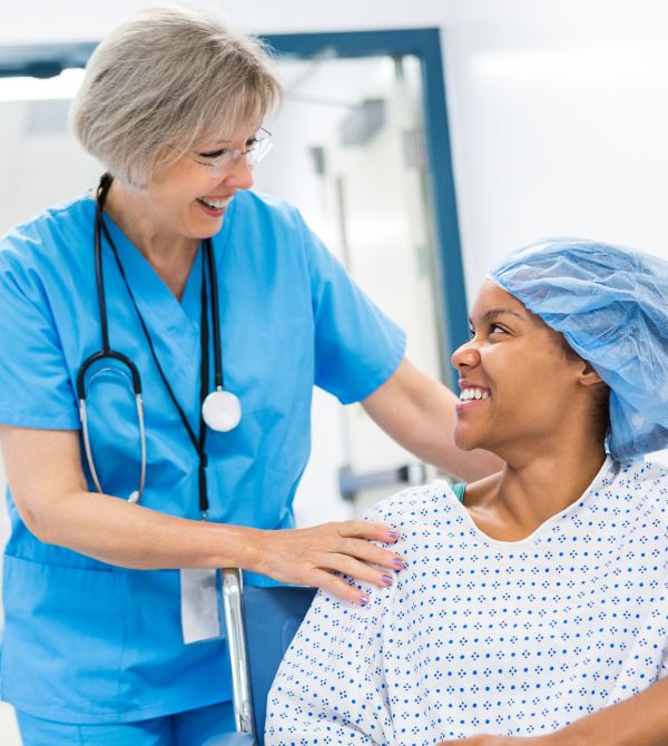 Nurse talking to patient recovering from surgery