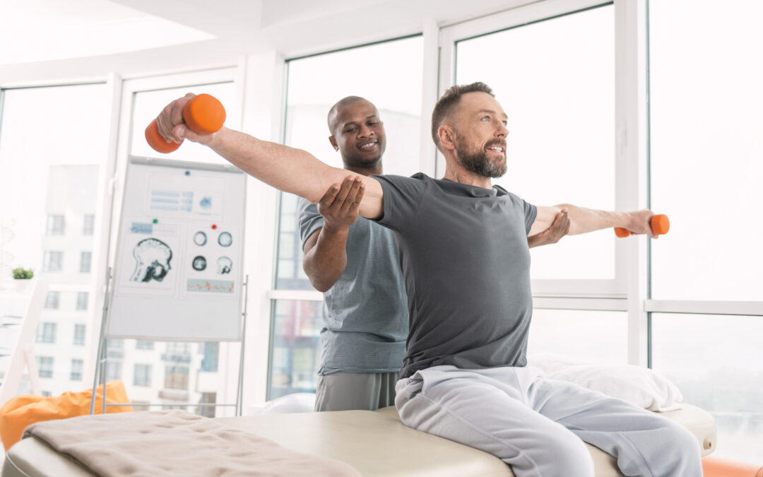 Physical therapy expert standing behind his patient while fixing his hands in post isometric relaxation